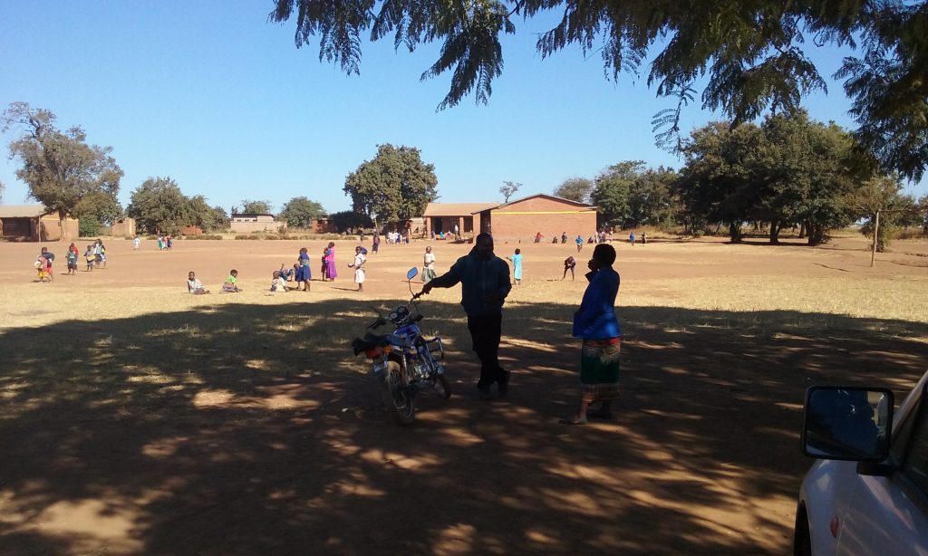 Willies talking motorcycles at Chitukula national school, one of our survey sites.