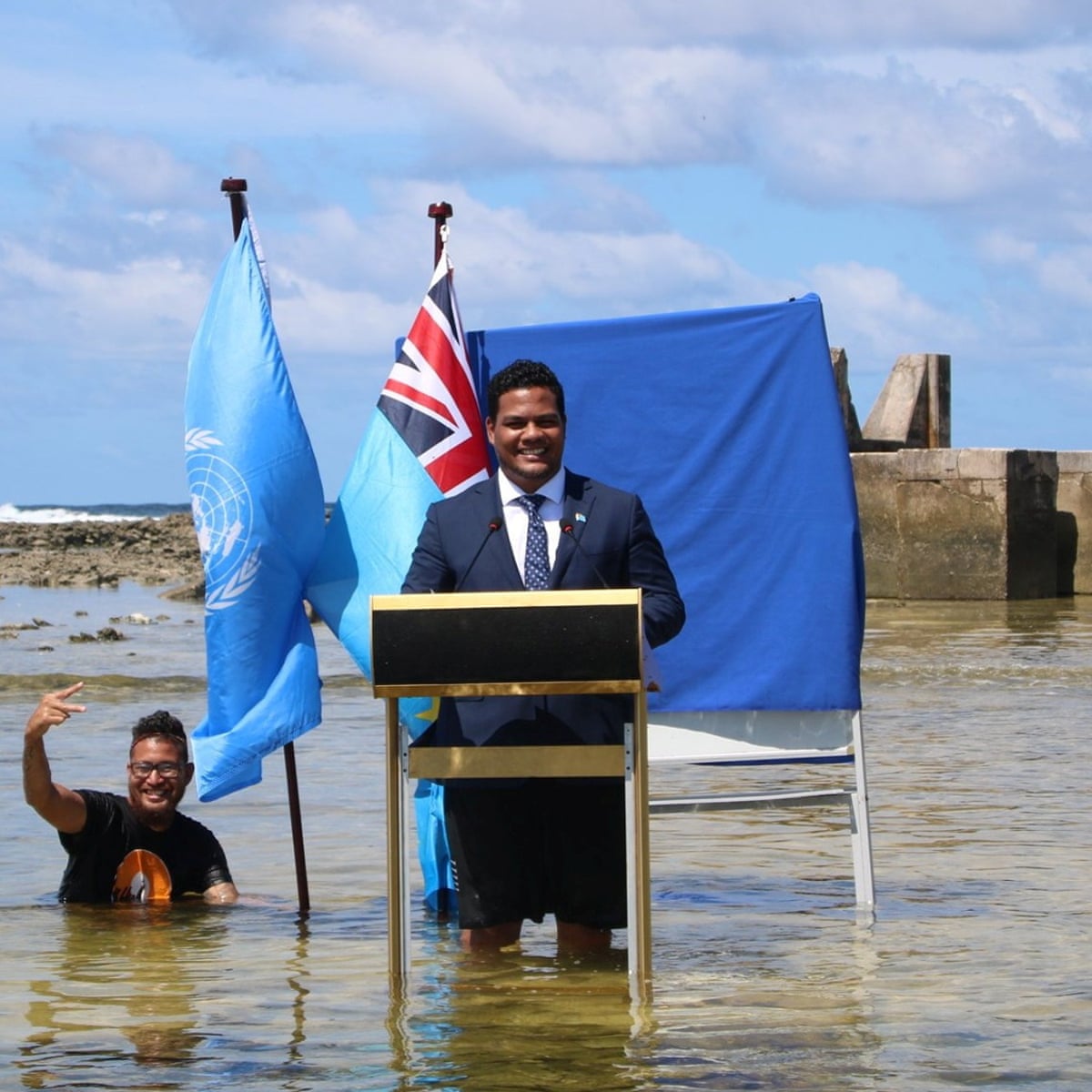 Delegate from Tuvalu standing in water to highlight the impacts of loss and damage